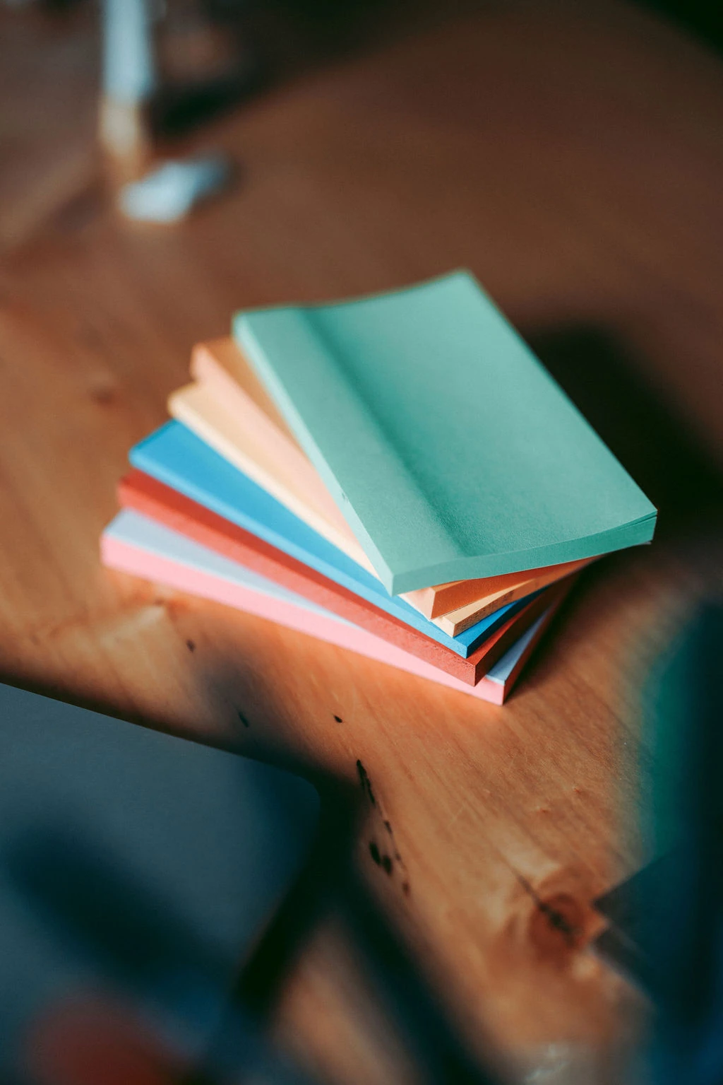Stack of coloured moderation cards on a wooden table