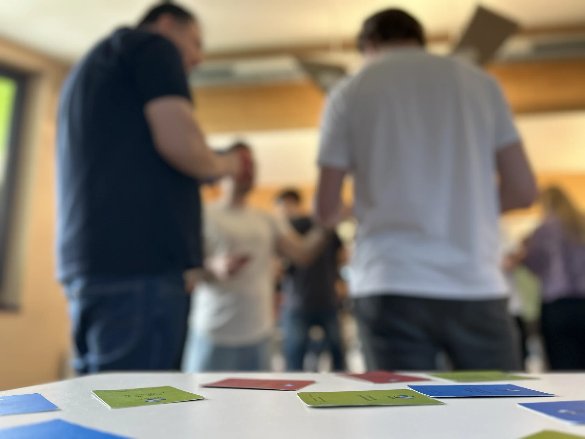 Moderation cards on the table with participants talking in the background